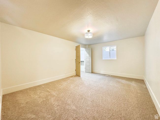 Empty room featuring light colored carpet and a textured ceiling | Image 39