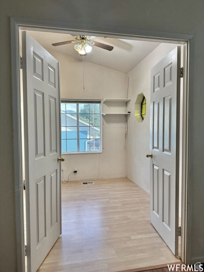 Interior space featuring a ceiling fan, light wood-style floors, and visible vents | Image 29