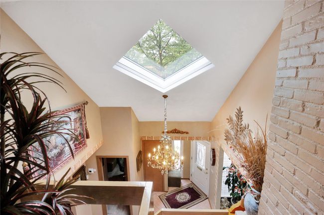 Living room with a light tile patterned flooring, and recessed lighting | Image 6