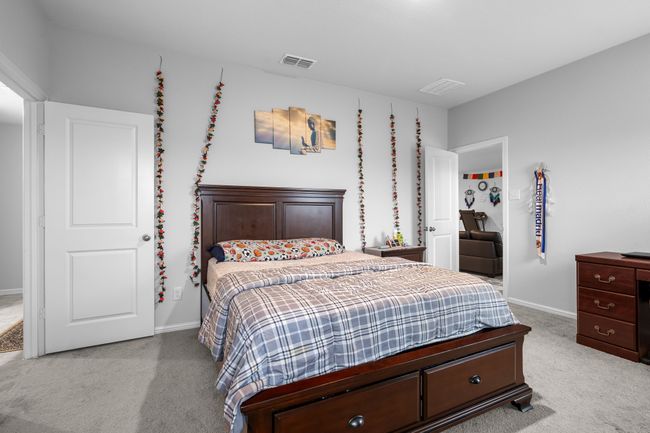 Bedroom with baseboards, light colored carpet, and visible vents | Image 15