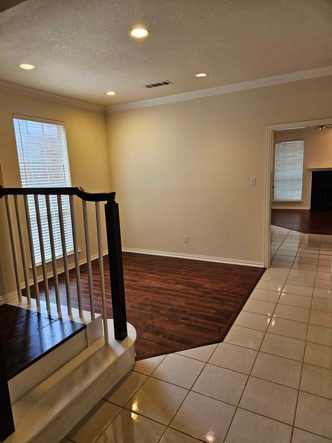 Stairs with a textured ceiling, recessed lighting, tile patterned flooring, and crown molding | Image 9