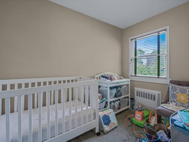 Carpeted bedroom featuring radiator heating unit | Image 14