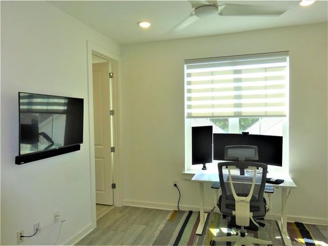 Office featuring wood finished floors, baseboards, recessed lighting, and a ceiling fan | Image 17