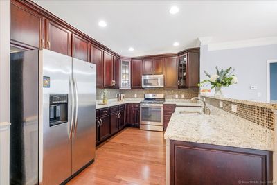 Beautiful cabinetry with 2 elegant glass front cabinets. | Image 3