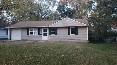 View of front of house with a garage and a front yard | Image 1