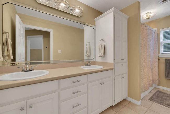 Tub/shower combo, double vanity sink, and tons of built-in storage for the second bathroom! | Image 36