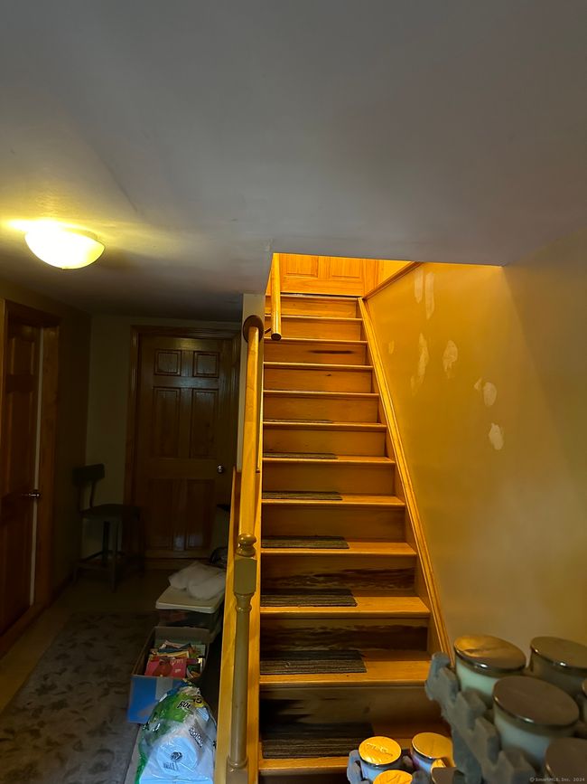 Tiled entryway with custom oak stairway | Image 18