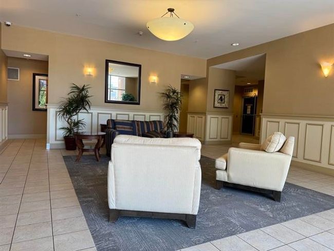 Community lobby featuring a decorative wall, a wainscoted wall, and recessed lighting | Image 7