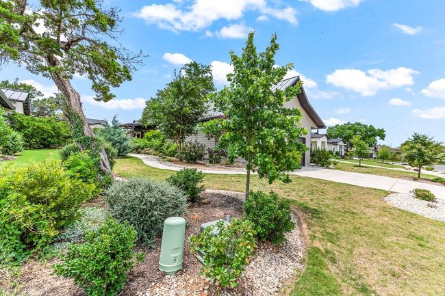 View of grassy yard featuring concrete driveway | Image 14