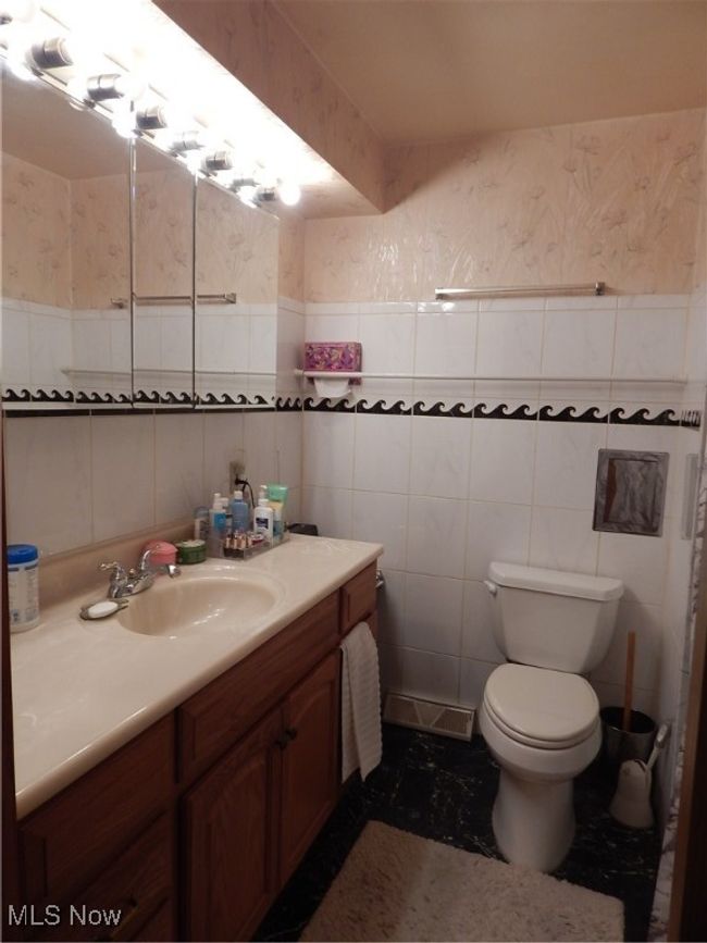 Full Hall Bathroom featuring tile walls, toilet and vanity & New Shower (2024) | Image 17