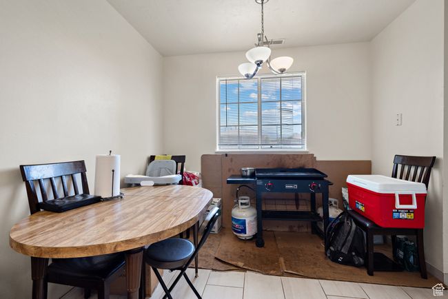 Tiled dining space featuring a chandelier | Image 12