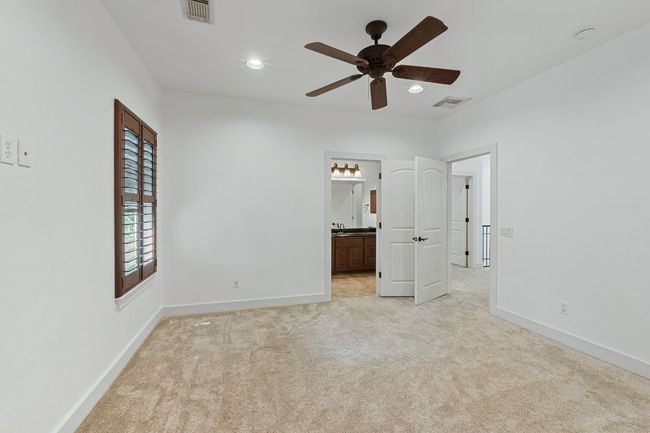 Unfurnished bedroom featuring light colored carpet, recessed lighting, connected bathroom, and a ceiling fan | Image 24
