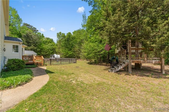View of yard with a wooden deck and stairs | Image 7