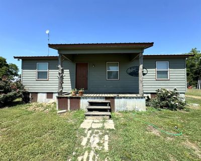 View of front facade with a front lawn | Image 1