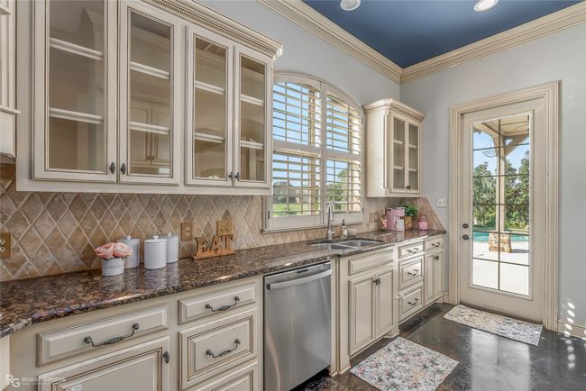 This kitchen is amazing! Love that you can easily get food to the pool area to grill. | Image 8