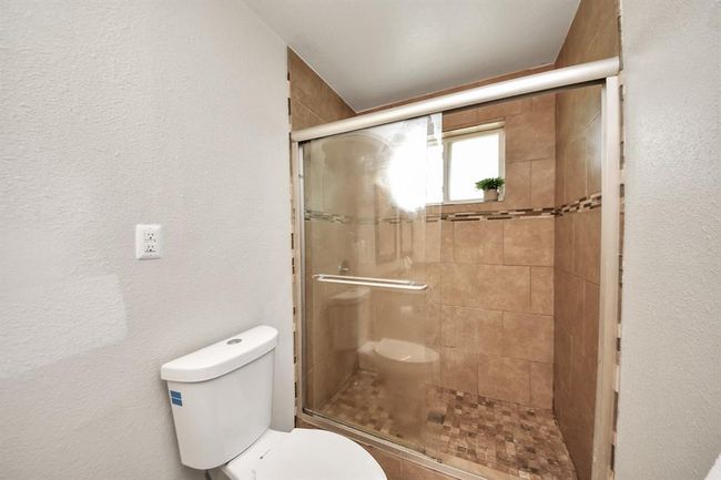 Spacious walk-in shower with clean, modern finishes—easy to love, easy to use. | Image 24