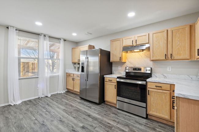 Kitchen featuring appliances with stainless steel finishes and enough space to add an island | Image 8