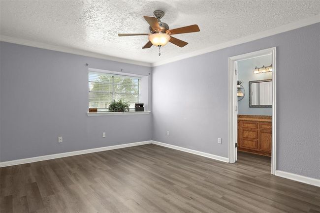 Roomy Primary Bedroom with Decorative Window Ledge | Image 7