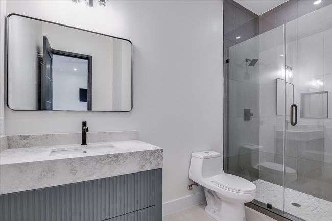 Bathroom featuring vanity and a walk in shower stall | Image 28