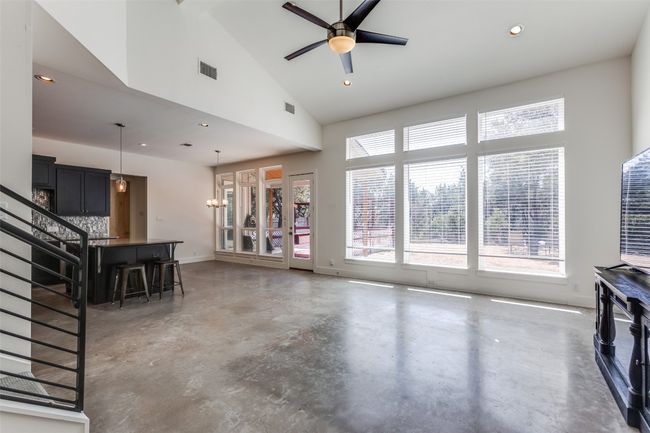 Living area featuring visible vents, ceiling fan, concrete floors, high vaulted ceiling, and recessed lighting | Image 5