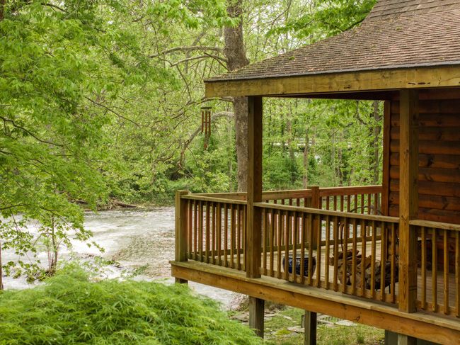 Wooden deck with a wooded view and a water view | Image 25