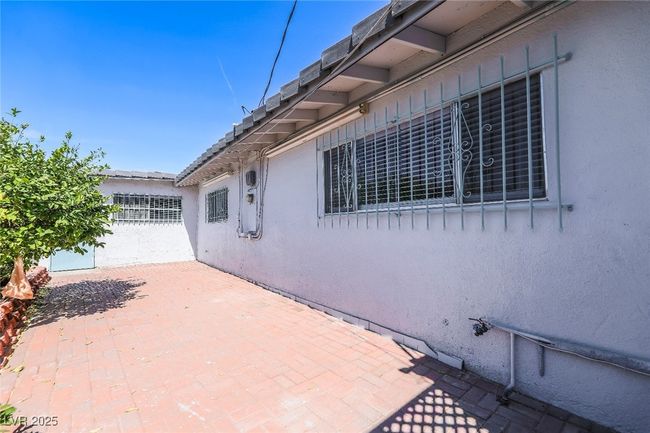 View of side of property featuring stucco siding and a patio | Image 52