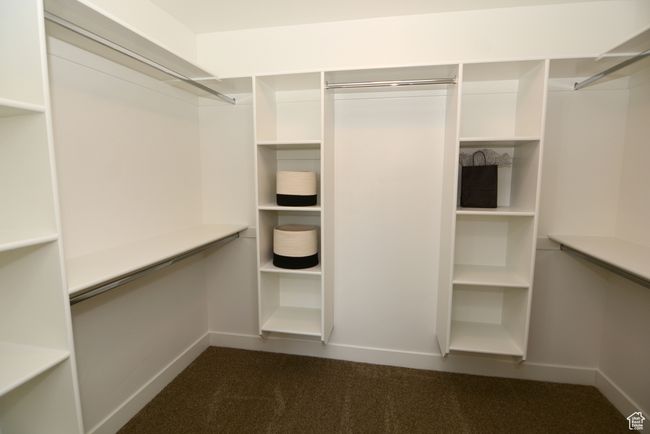 Spacious closet featuring dark carpet | Image 7