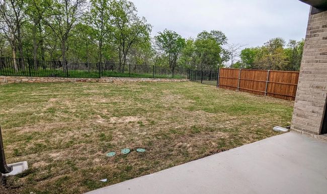 View of yard with a patio area and a fenced backyard | Image 23