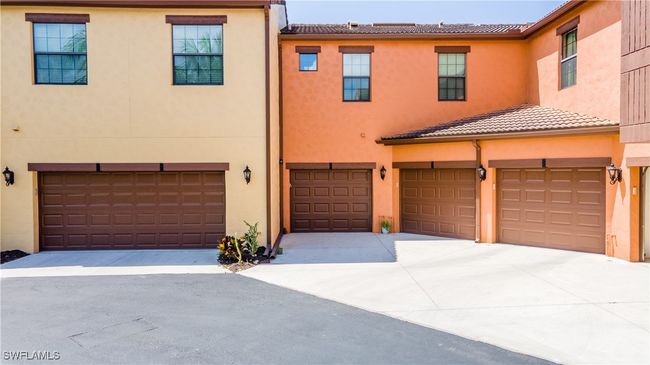 Multi unit property featuring a tile roof, an attached garage, and stucco siding | Image 25