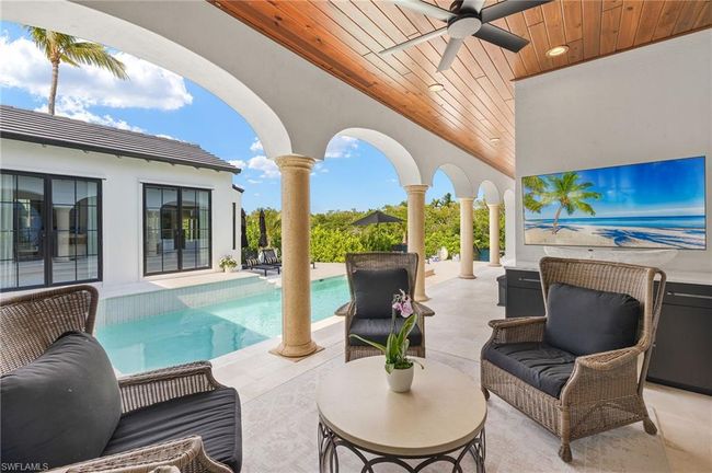 View of patio featuring an outdoor pool, ceiling fan, and an outdoor hangout area | Image 40