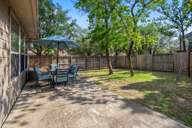 Stepping out the back door, you'll find an extended patio, perfect for outdoor dining, entertaining, or relaxing while enjoying the spacious backyard. | Image 34