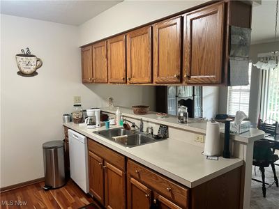 Kitchen with white dishwasher, sink, and dark hardwood / wood-style flooring | Image 2