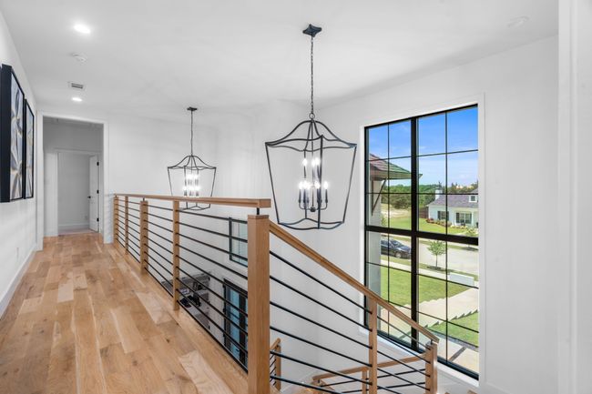 Hall with a chandelier, an upstairs landing, light wood-style floors, baseboards, and recessed lighting | Image 19
