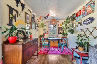 Rec room with ornamental molding and dark hardwood / wood-style floors | Image 2