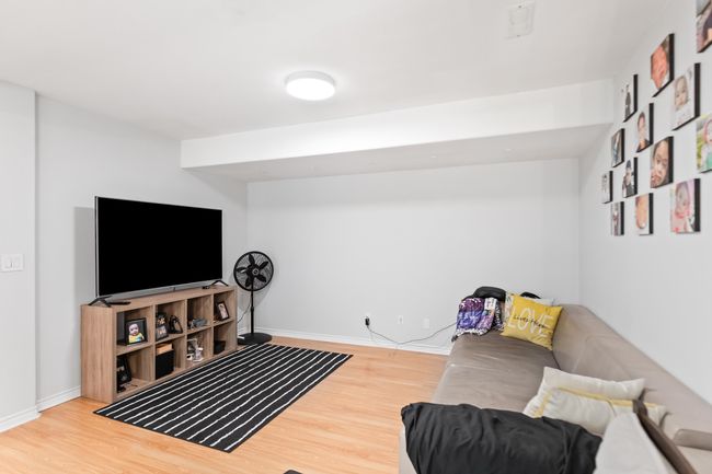 Living room with wood finished floors and baseboards | Image 17