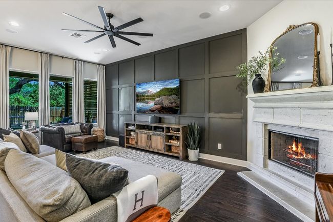 Living area with recessed lighting, dark wood-style floors, a ceiling fan, visible vents, and a decorative wall | Image 6
