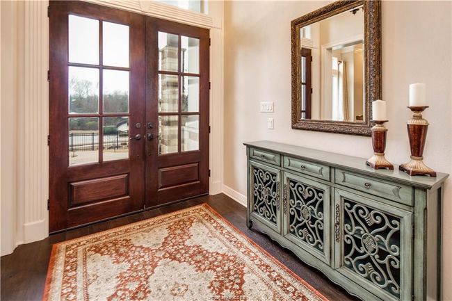Doorway with baseboards, dark wood-style floors, and french doors | Image 5