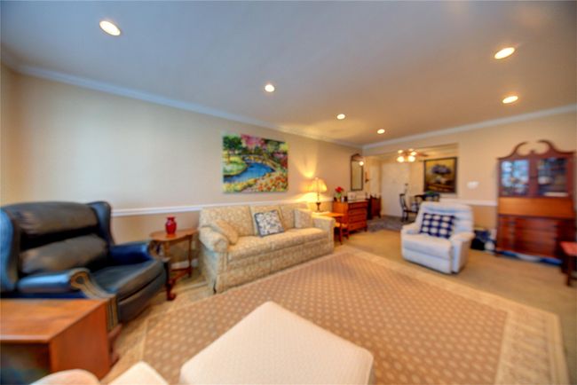 Living room with carpet floors, ornamental molding, and recessed lighting | Image 13