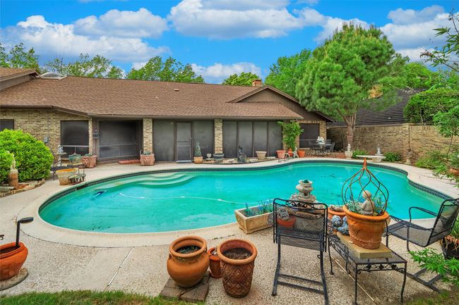 View of swimming pool featuring fence, a patio area, and a fenced in pool | Image 9