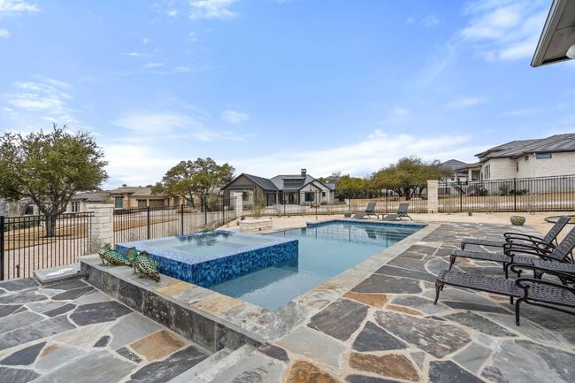 View of pool featuring a pool with connected hot tub, a patio, and fence | Image 38