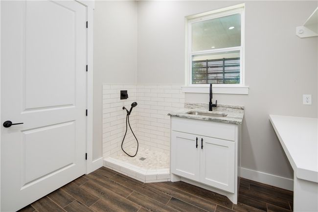 Full bathroom with a tile shower, wood finished floors, and vanity | Image 18