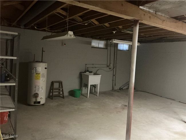 Basement with sink and water heater | Image 16