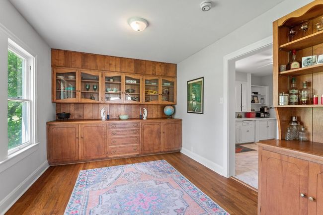 Dining room features stunning, original built-ins. Includes glass cabinets, buffet, lower storage and amazing time-period bar | Image 8