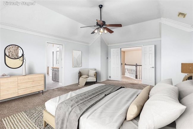 Upstairs, the spacious primary bedroom is straight up the stairs and has been recently painted a creamy white neutral color (VIRTUALLY STAGED) | Image 21