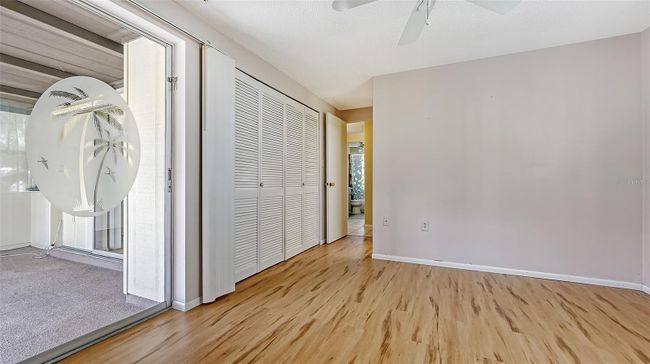 Primary Bedroom with sliders to the enclosed Florida room. | Image 16