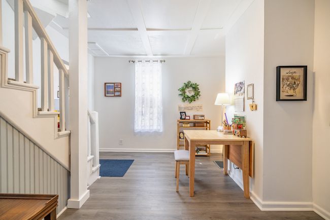 Office featuring coffered ceiling, wood finished floors, baseboards, and beamed ceiling | Image 9