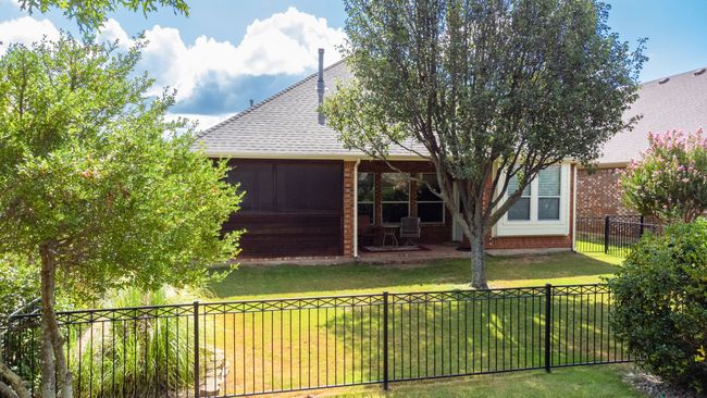 Rear view of property with brick siding, roof with shingles, and a patio area | Image 25