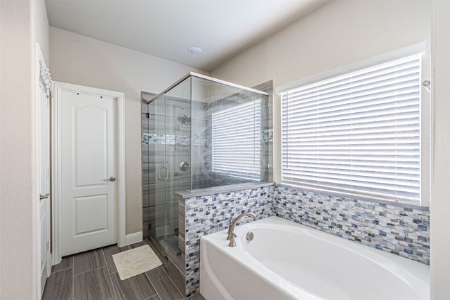 Full bath featuring a bath and a shower stall | Image 20