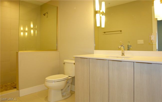 Bathroom with walk in shower, vanity, and tile patterned floors | Image 5