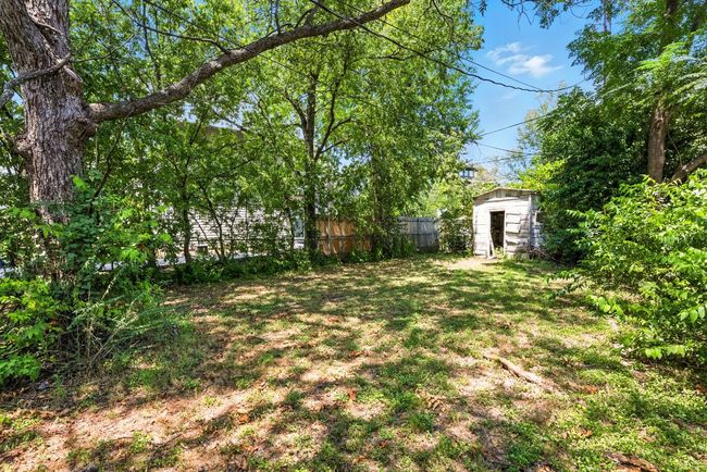 View of yard with a storage shed | Image 7